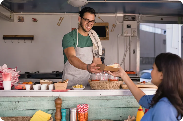 a man serving food to a customer